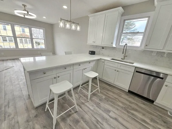a kitchen with a sink cabinets and window