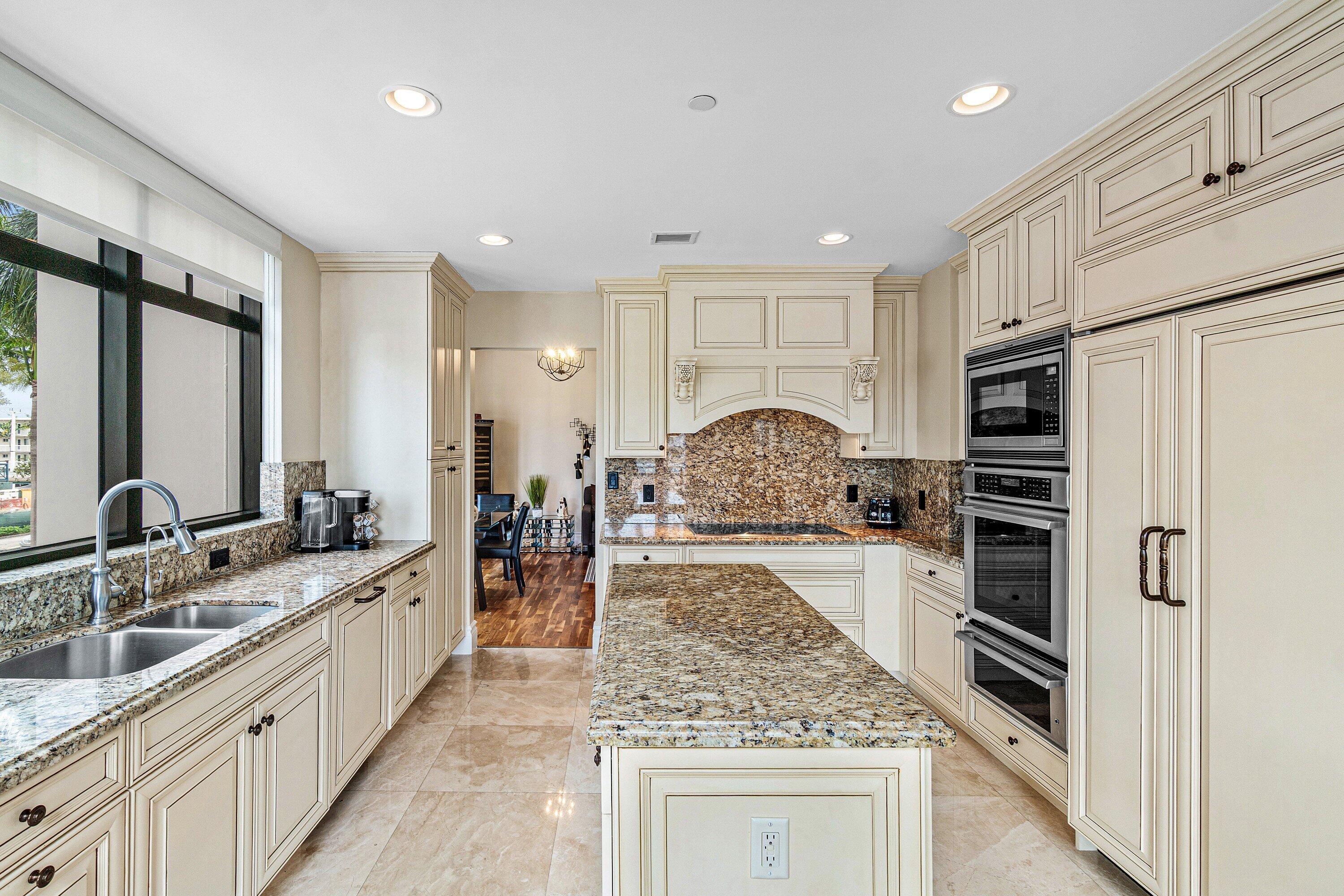 200 East Palmetto Park Road, Unit 22 Boca Raton, FL 33432 - Photo 11 of 44 a large kitchen with stainless steel appliances granite countertop a stove oven and a refrigerator