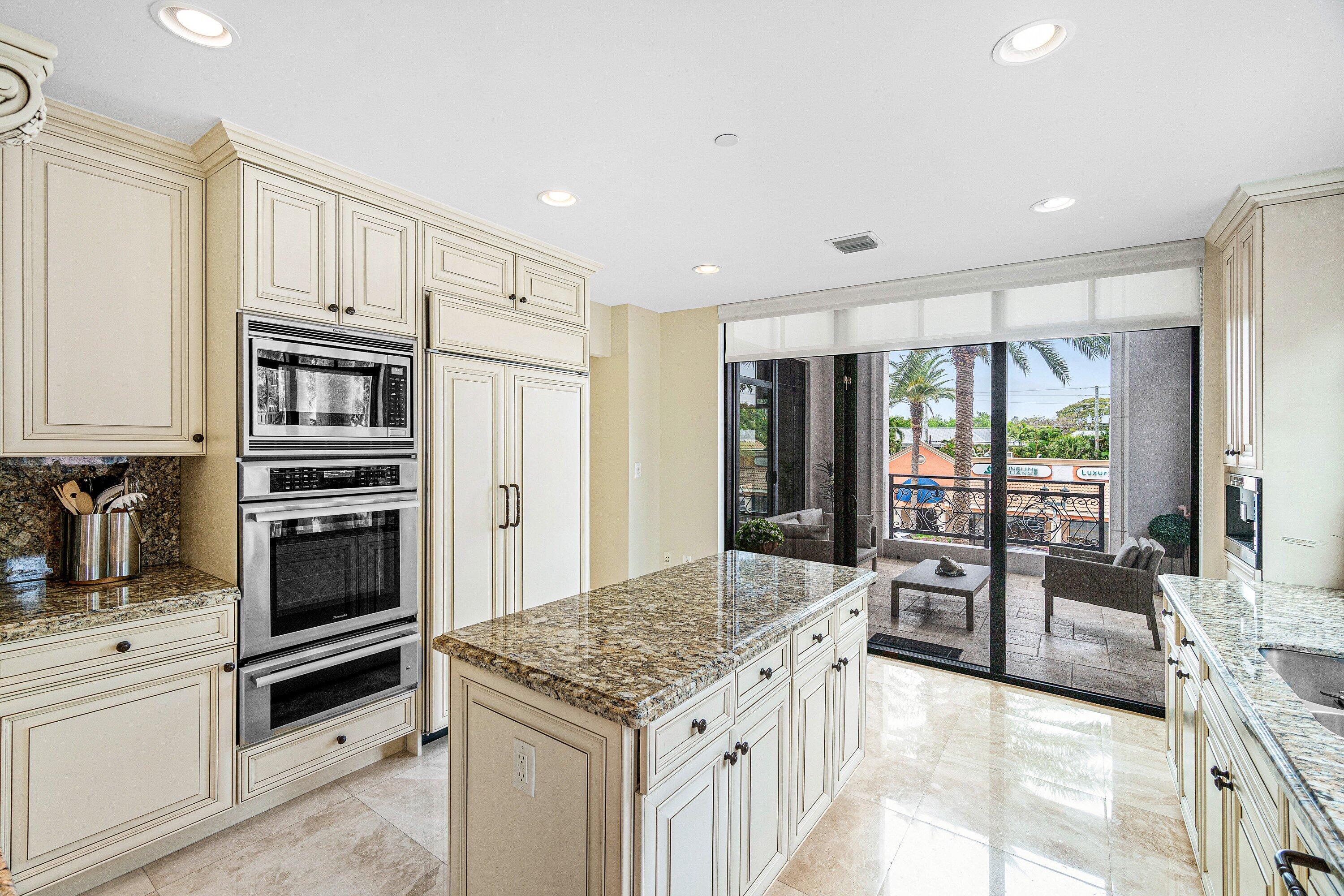 200 East Palmetto Park Road, Unit 22 Boca Raton, FL 33432 - Photo 12 of 44 a kitchen with stainless steel appliances granite countertop a stove and a refrigerator