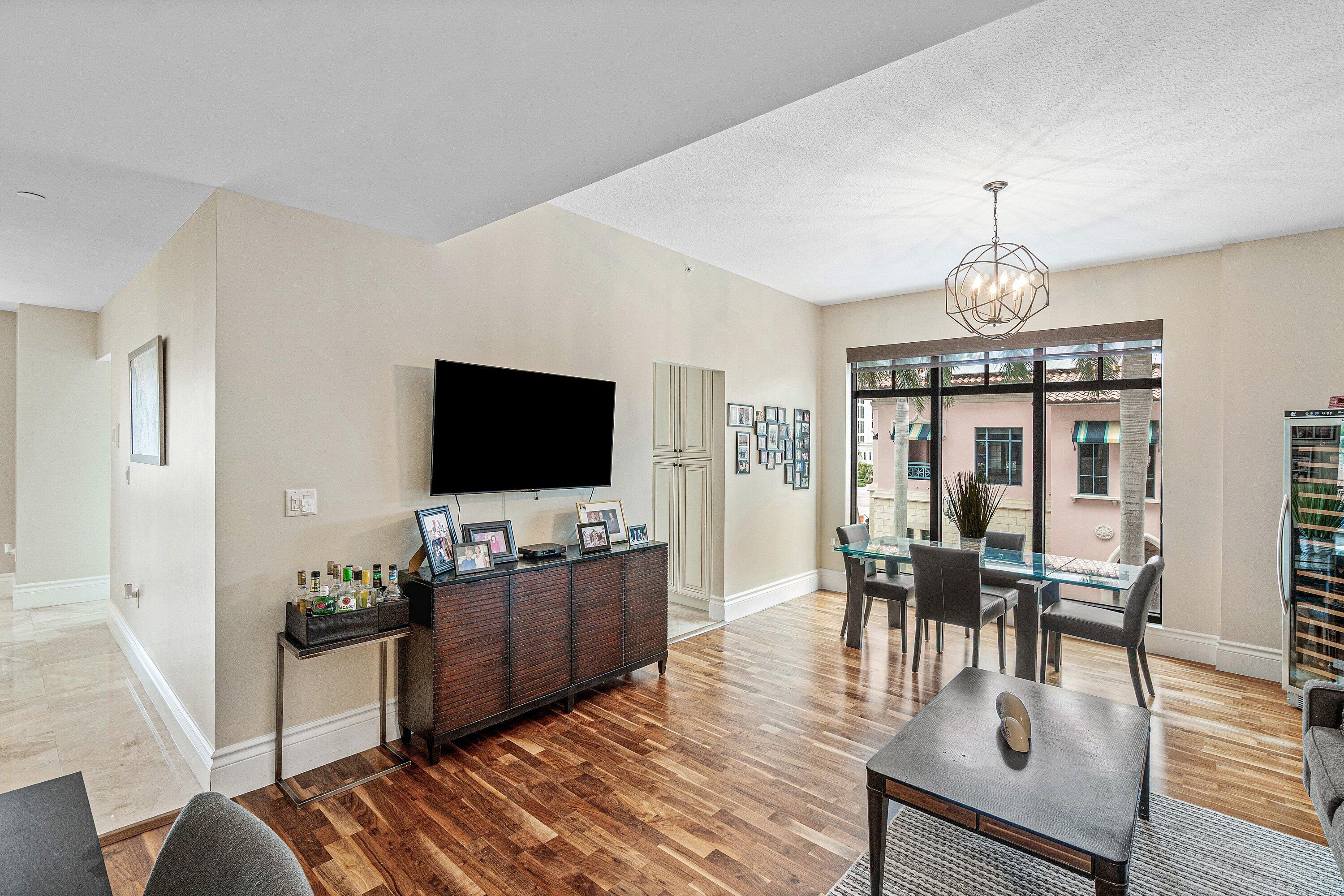 200 East Palmetto Park Road, Unit 22 Boca Raton, FL 33432 - Photo 18 of 44 a living room with furniture a dining table and a flat screen tv