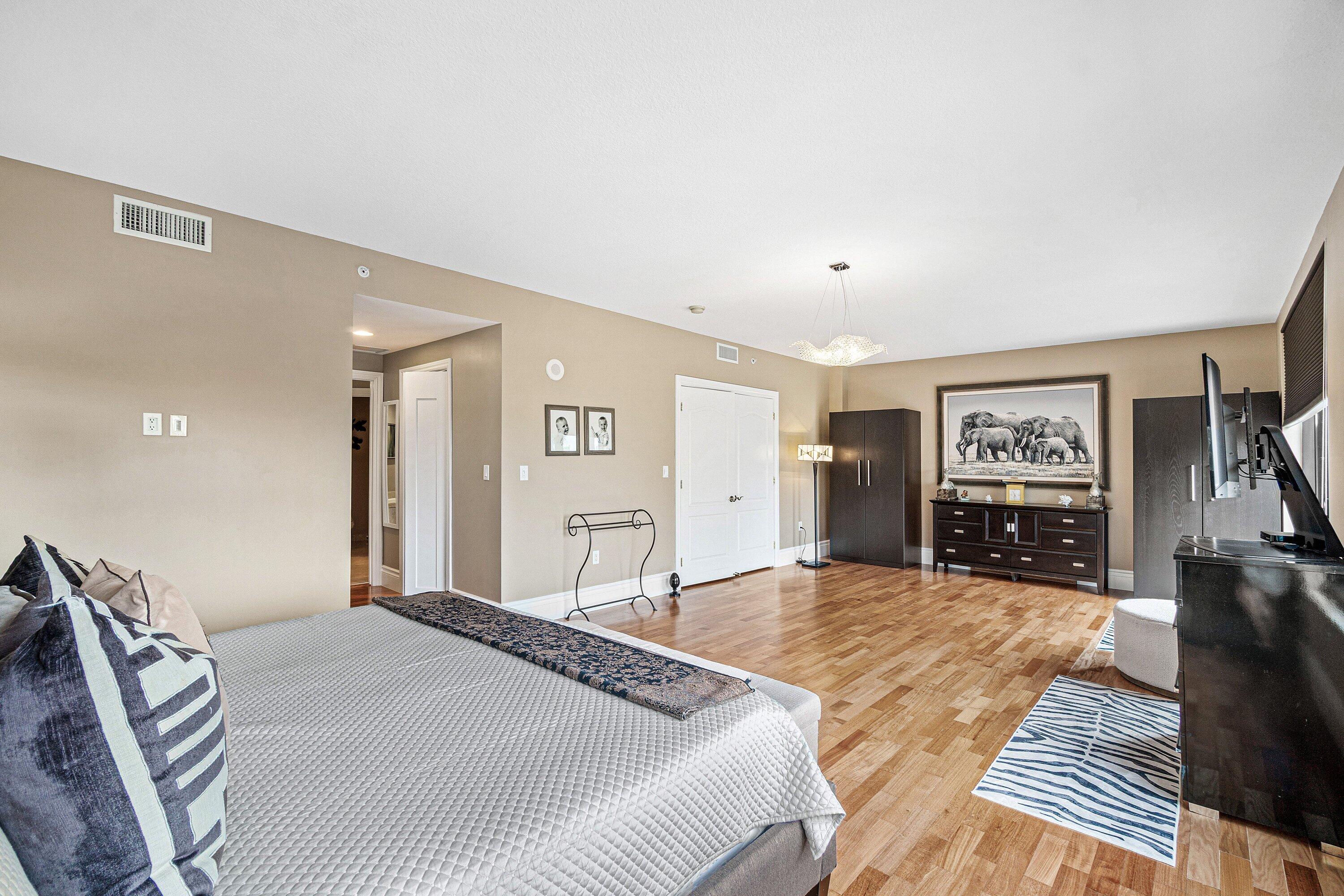 200 East Palmetto Park Road, Unit 22 Boca Raton, FL 33432 - Photo 21 of 44 a spacious bedroom with a bed and a view of kitchen
