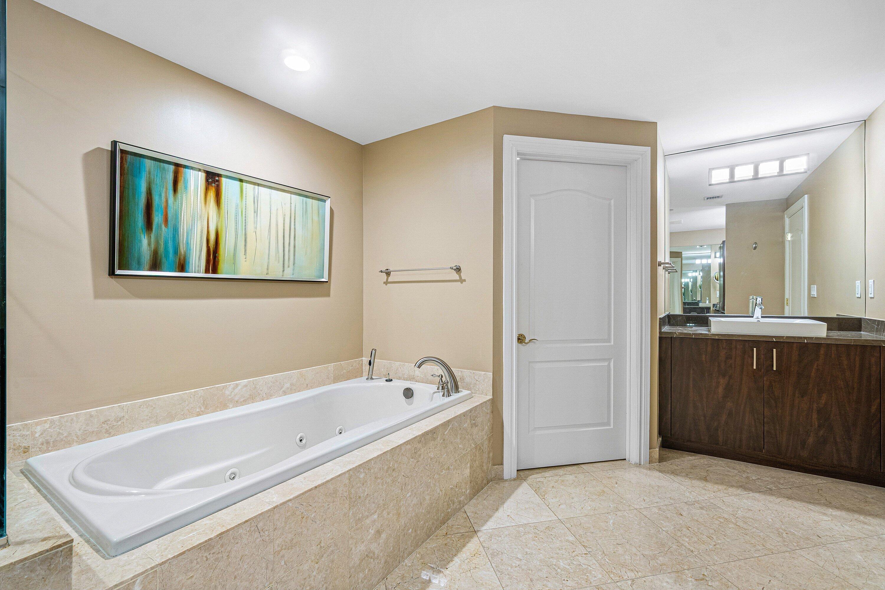 200 East Palmetto Park Road, Unit 22 Boca Raton, FL 33432 - Photo 26 of 44 a spacious bathroom with a tub sink and mirror
