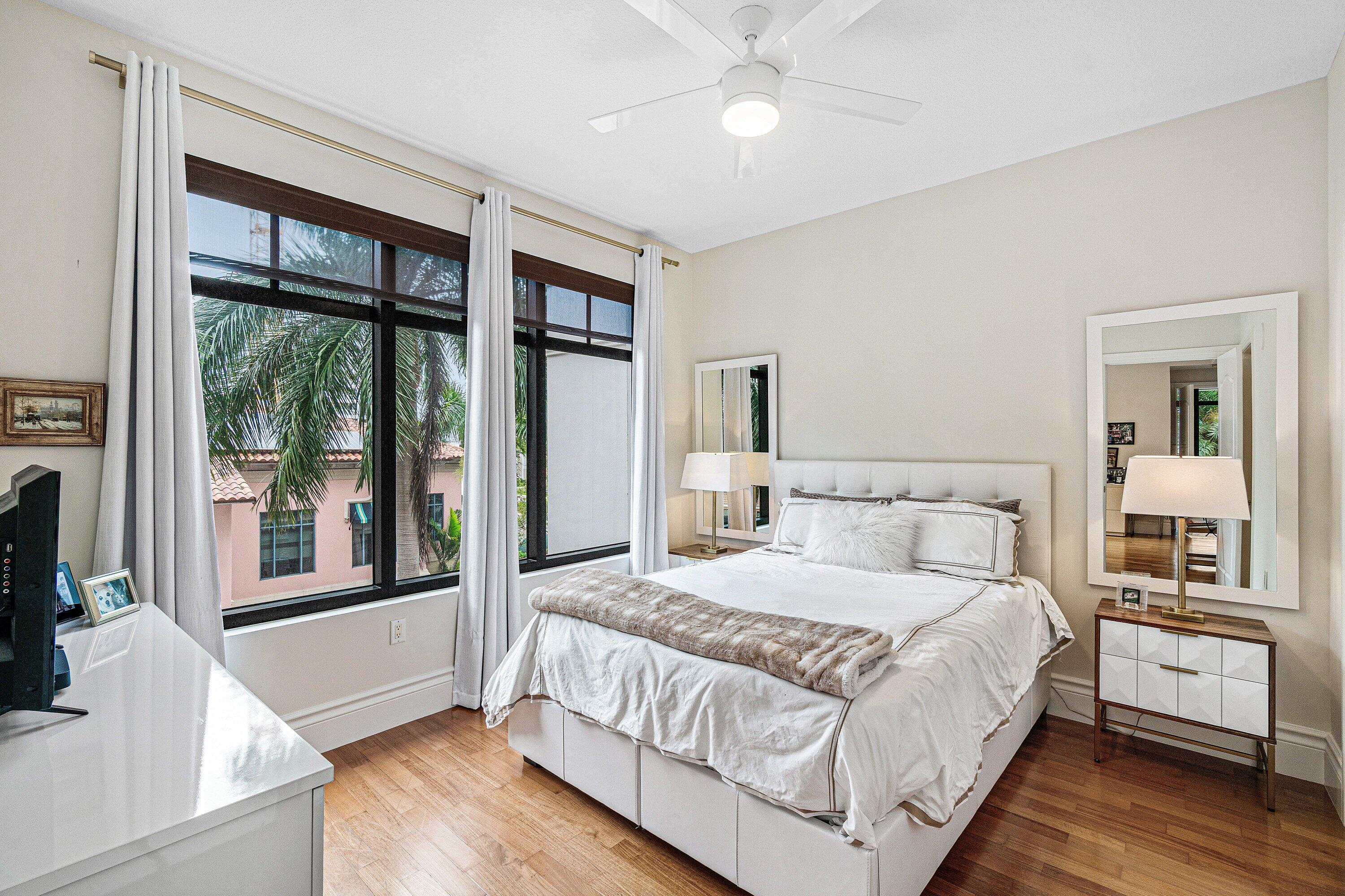 200 East Palmetto Park Road, Unit 22 Boca Raton, FL 33432 - Photo 29 of 44 a bedroom with a large bed and a large window