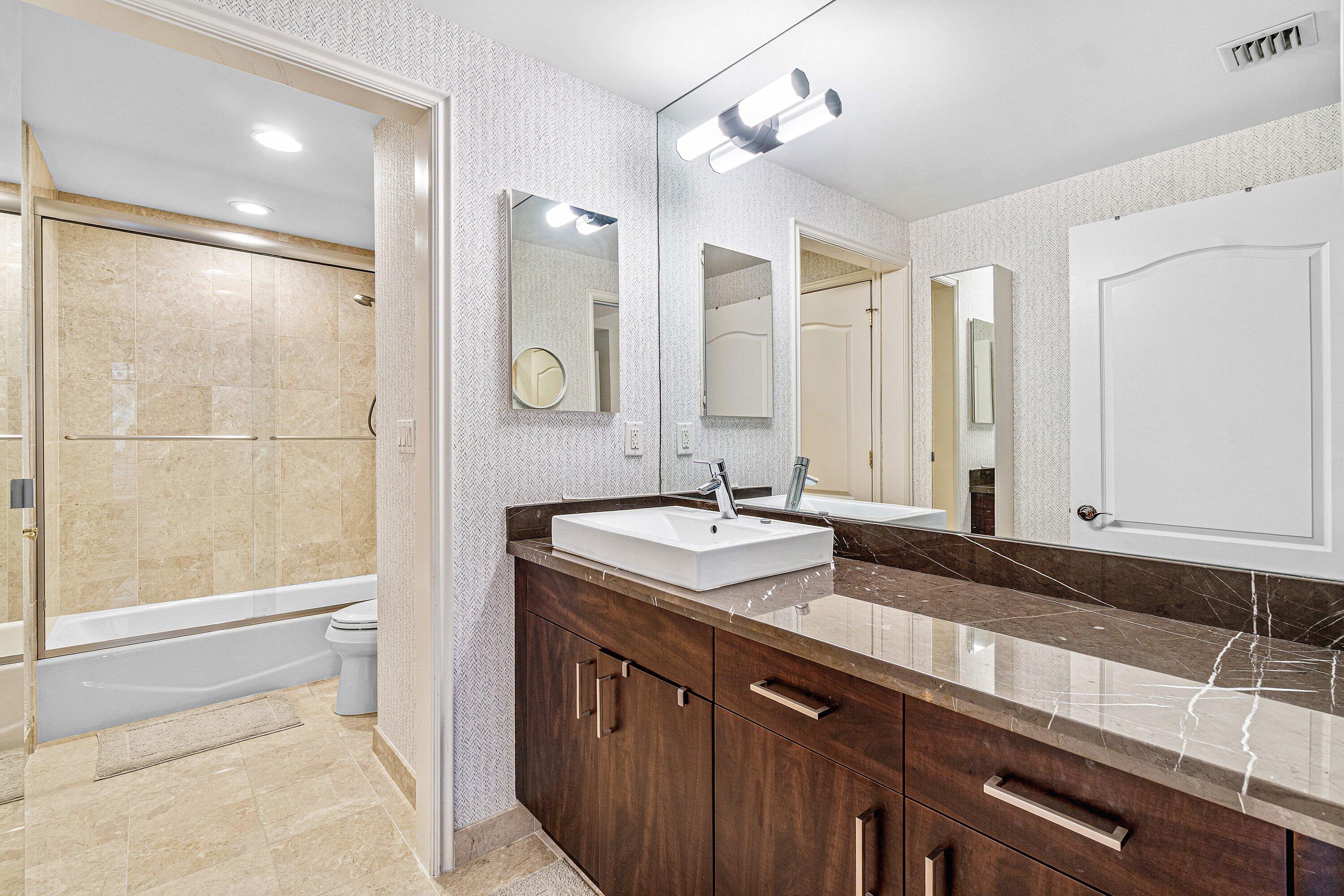 200 East Palmetto Park Road, Unit 22 Boca Raton, FL 33432 - Photo 32 of 44 a bathroom with a sink and a mirror
