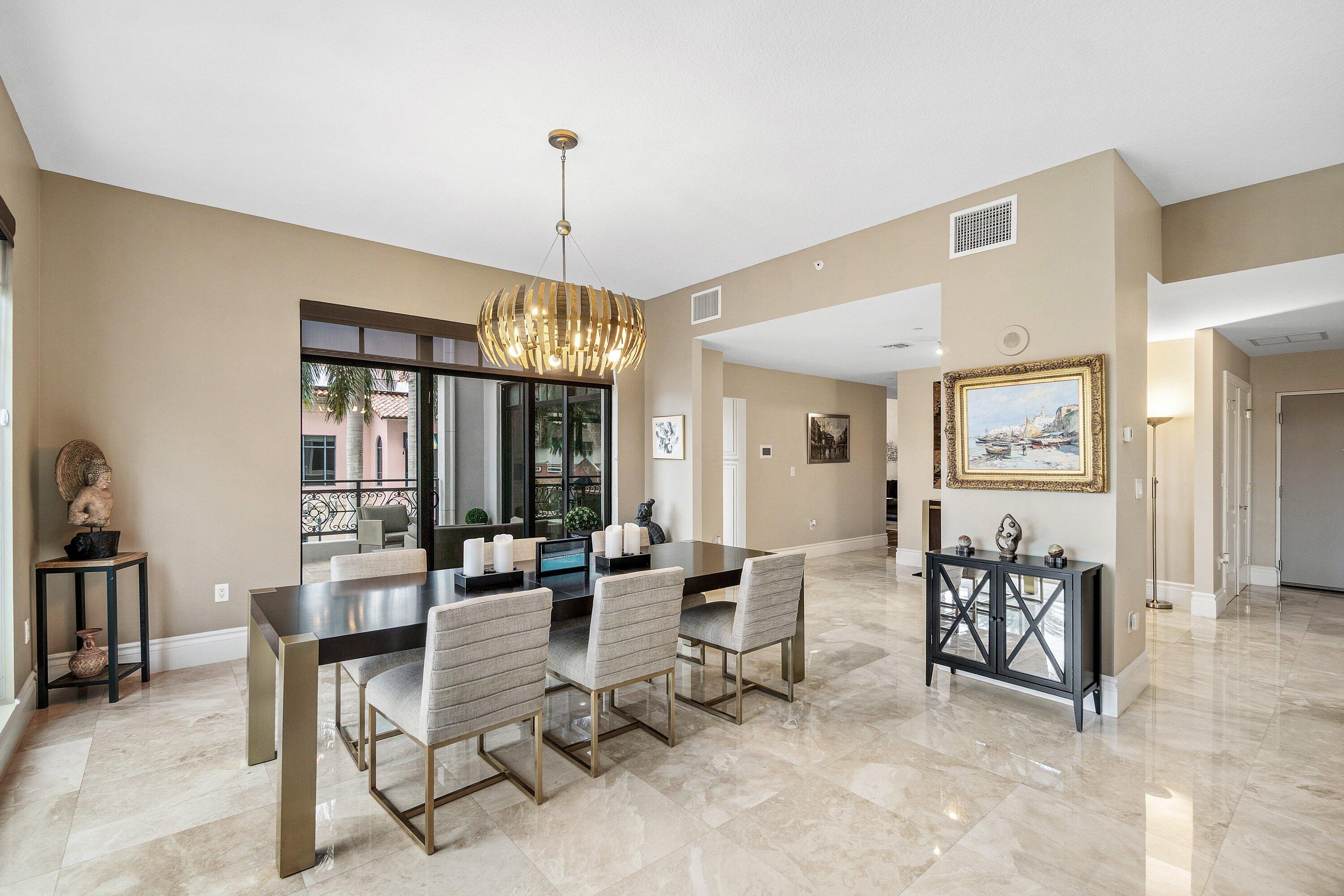 200 East Palmetto Park Road, Unit 22 Boca Raton, FL 33432 - Photo 6 of 44 a living room with furniture a chandelier and a dining table