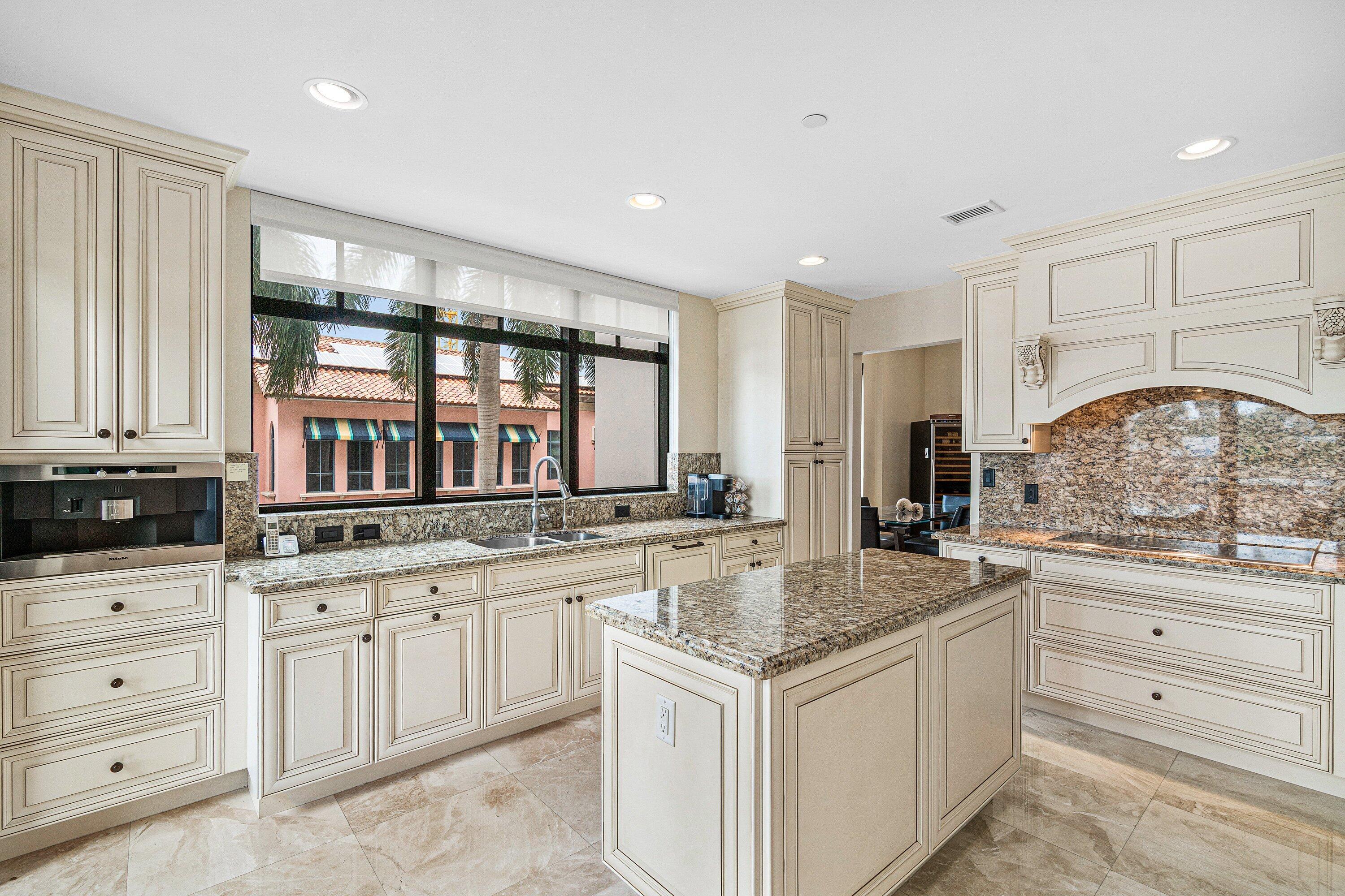 200 East Palmetto Park Road, Unit 22 Boca Raton, FL 33432 - Photo 9 of 44 a kitchen with granite countertop a sink and cabinets