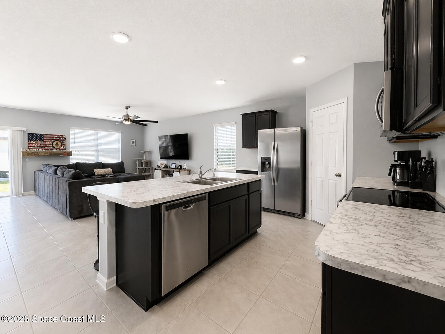 4731 Talbot Boulevard Cocoa, FL 32926 - Photo 7 of 18 a kitchen with stainless steel appliances kitchen island granite countertop a stove refrigerator and a sink