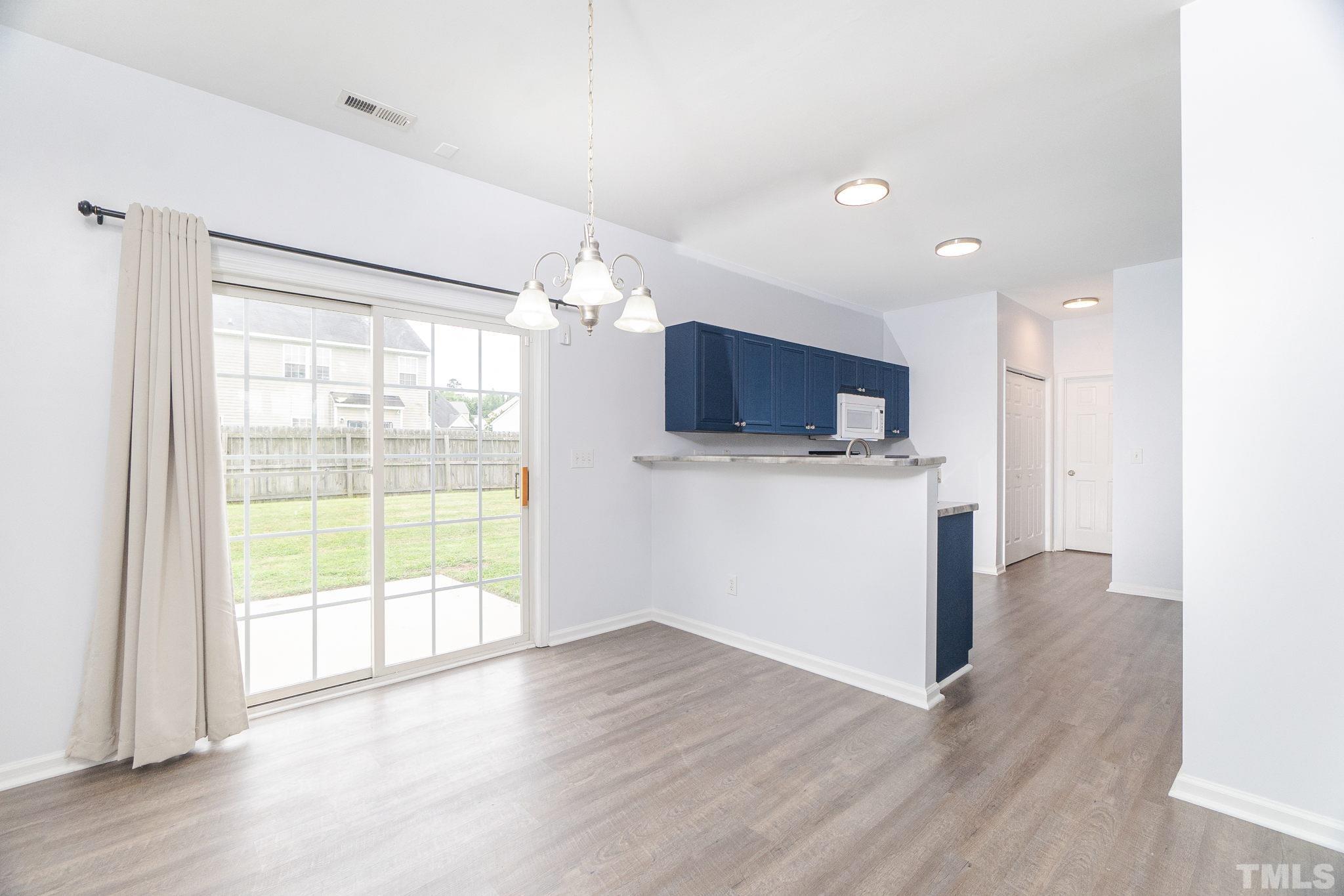 6920 Missionary Ridge Drive Raleigh, NC 27610 - Photo 11 of 34 a view of a kitchen with a stove wooden cabinets and wooden floor