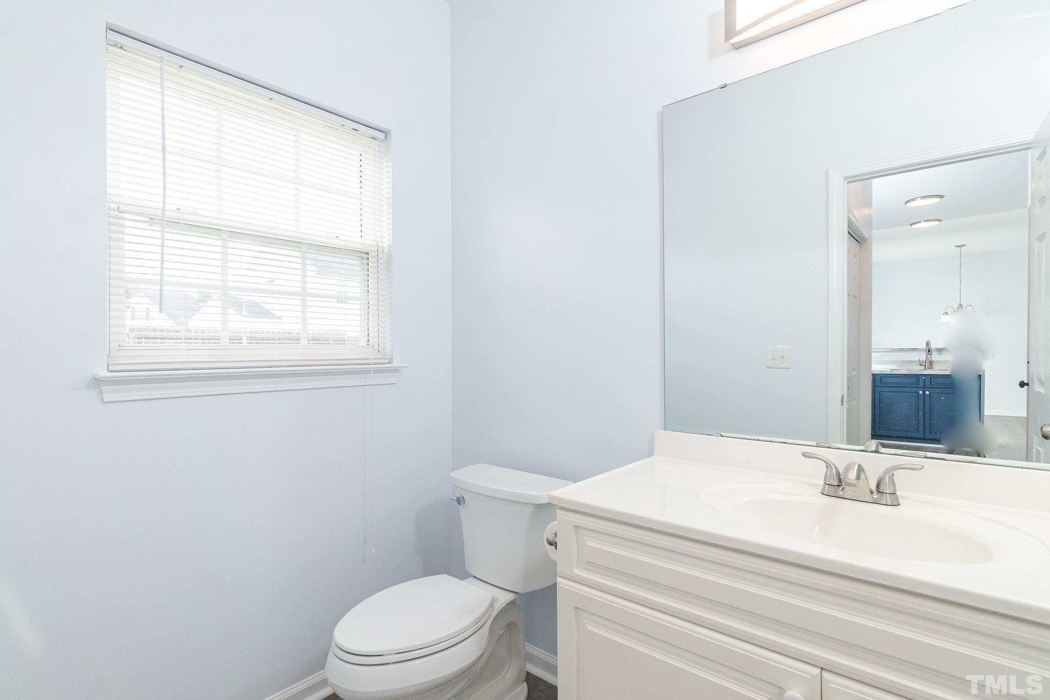 6920 Missionary Ridge Drive Raleigh, NC 27610 - Photo 18 of 34 a bathroom with a sink a toilet and a mirror