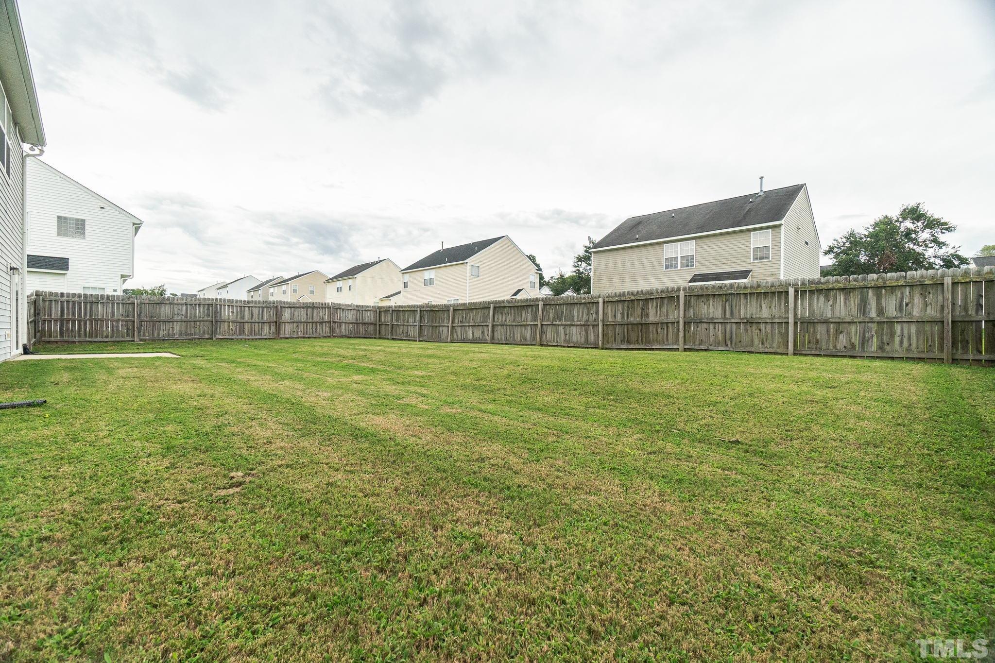 6920 Missionary Ridge Drive Raleigh, NC 27610 - Photo 33 of 34 a view of a green field with wooden fence