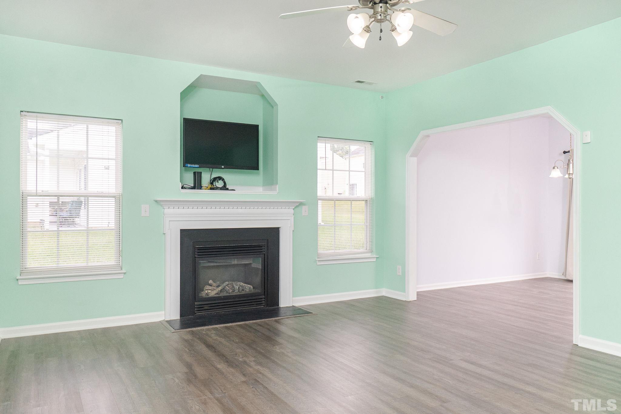 6920 Missionary Ridge Drive Raleigh, NC 27610 - Photo 8 of 34 a view of an empty room with wooden floor fireplace and a window