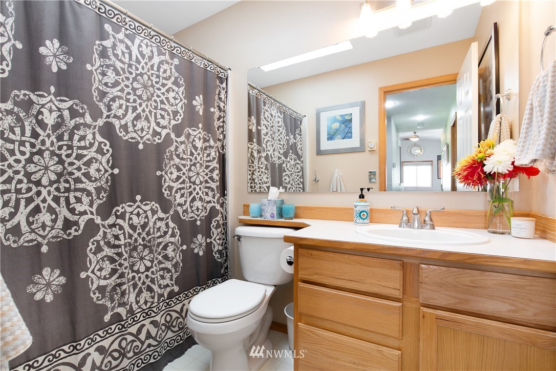 23718 Carter Road Bothell, WA 98021 - Photo 22 of 37 a bathroom with a granite countertop toilet sink and mirror