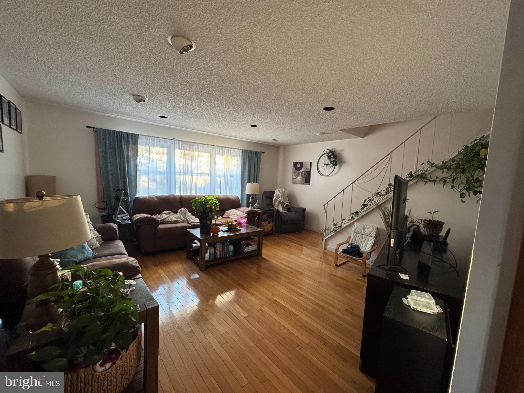 518 Parlin Street Philadelphia, PA 19116 - Photo 12 of 17 a living room with furniture floor to ceiling window and a wooden floor