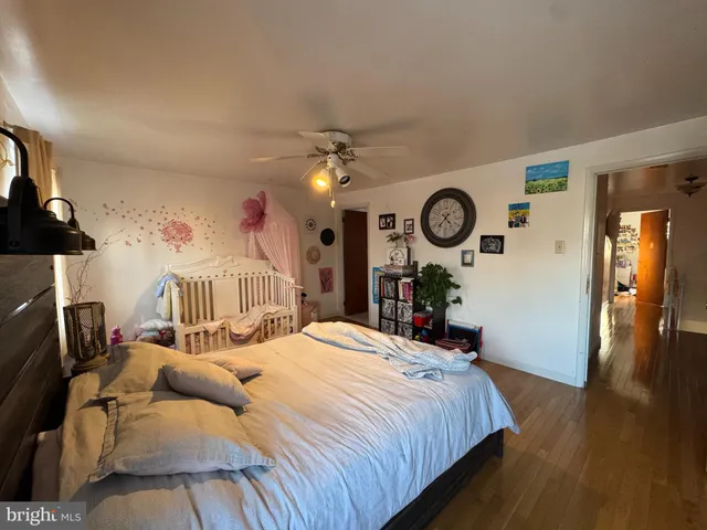 a bed room with a bed mirror and a window