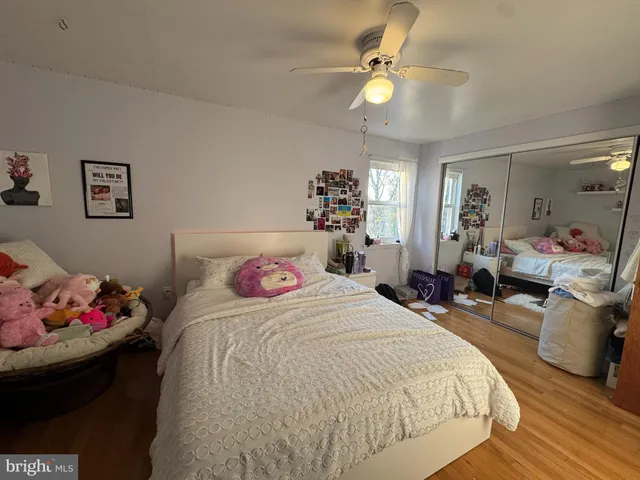 a bedroom with bed and a chandelier