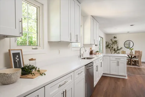 a kitchen with sink cabinets and window