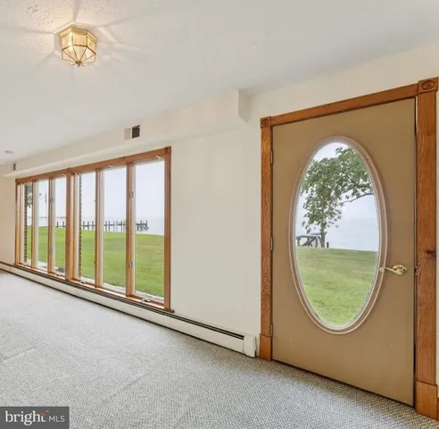 a view of a kitchen with refrigerator and a stove