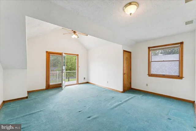 an empty room with a empty space and a ceiling fan