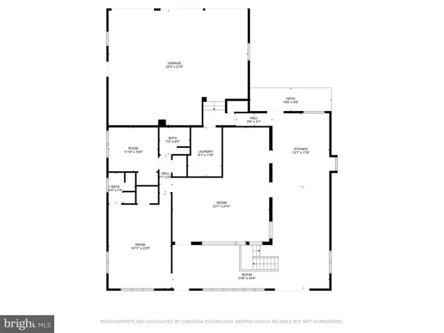 a black and white house with a big yard and large trees