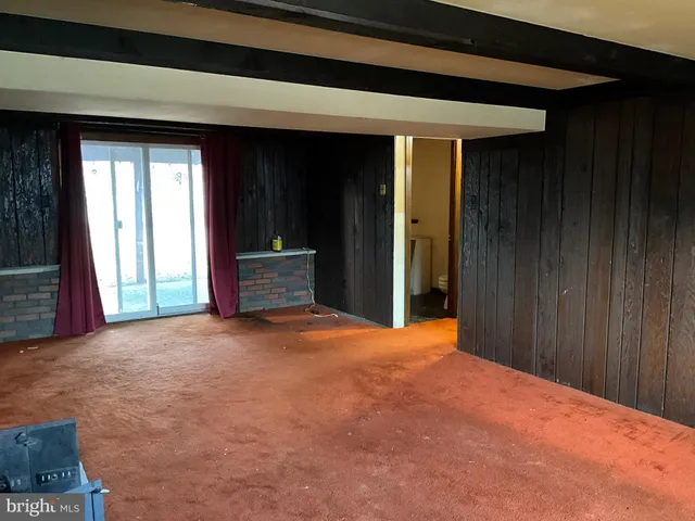 a view of an empty room with a closet