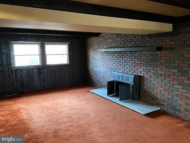 a view of empty room with a fireplace