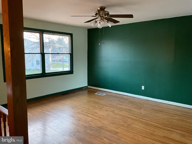 wooden floor in an empty room with a window