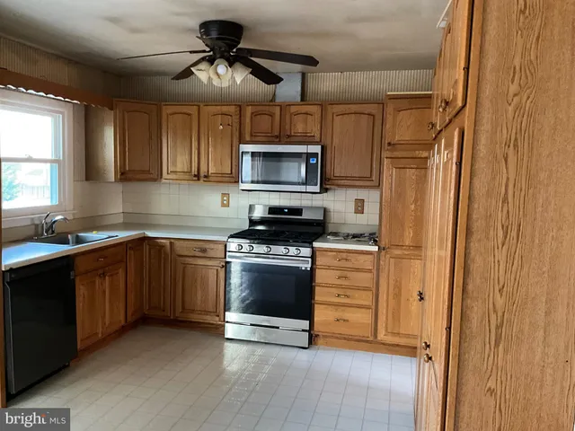 a kitchen with stainless steel appliances granite countertop a stove and a refrigerator