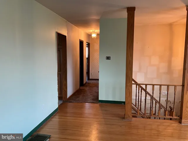 a view of hallway with wooden floor