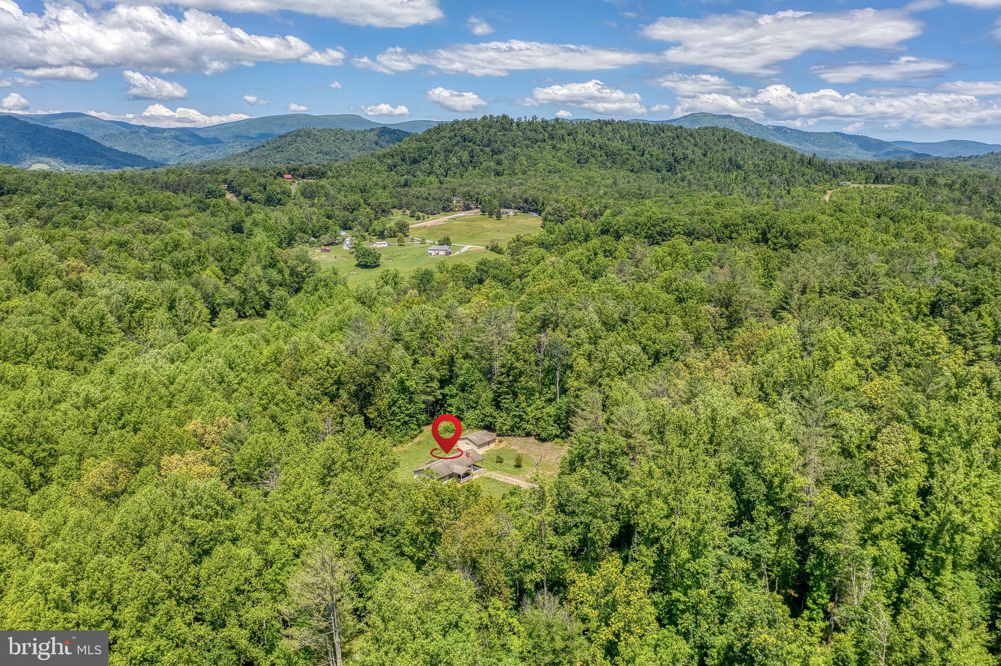 803 Weaver Hollow Road Banco, VA 22711 - Photo 50 of 67 a view of a green field with mountains in the background