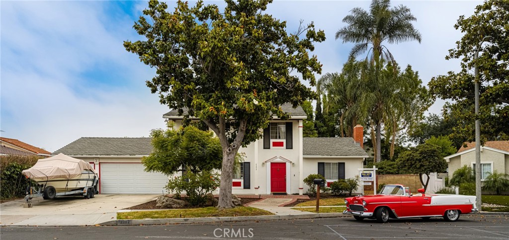 2202 East Olmstead Way Anaheim, CA 92806 - Photo 1 of 1 a front view of a house with cars parked