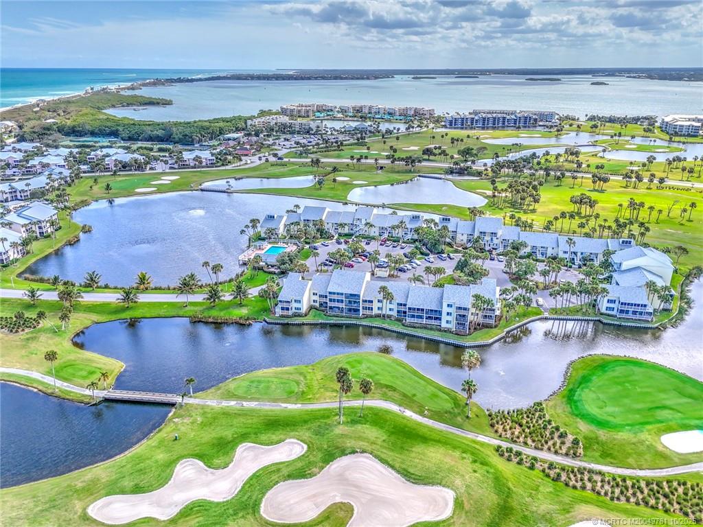 an aerial view of a house with a garden and lake view