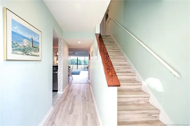 a kitchen with granite countertop white cabinets and stainless steel appliances