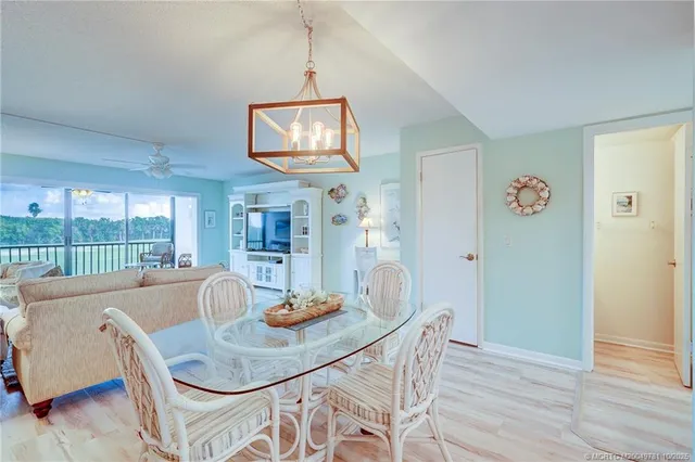 a living room with furniture large window and a flat screen tv