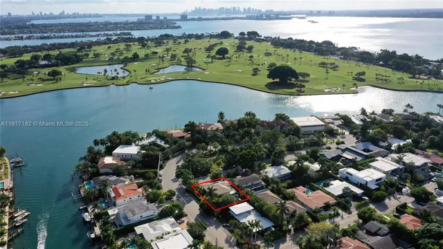 an aerial view of lake and houses with outdoor space