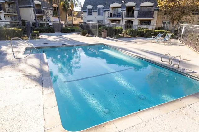 a view of a swimming pool with a yard