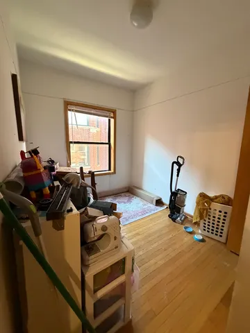 a bed sitting in a bedroom next to a window