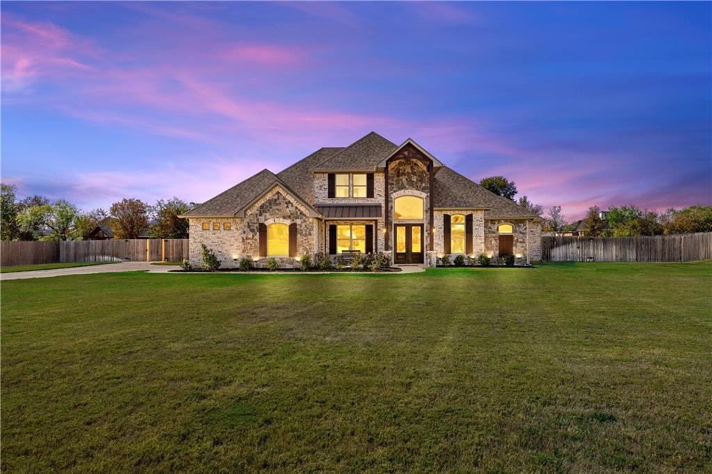 a front view of a house with a big yard