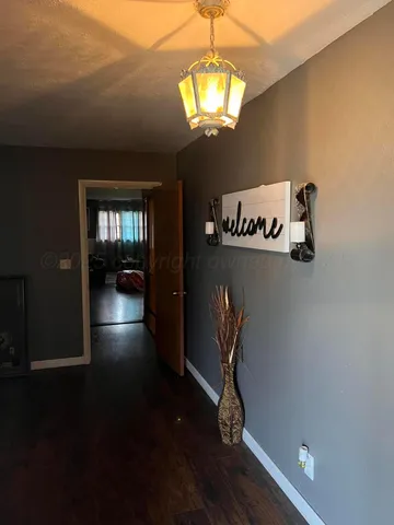 a view of a room with wooden floor gym equipment and windows