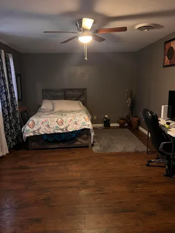 a bedroom with bed and a chandelier