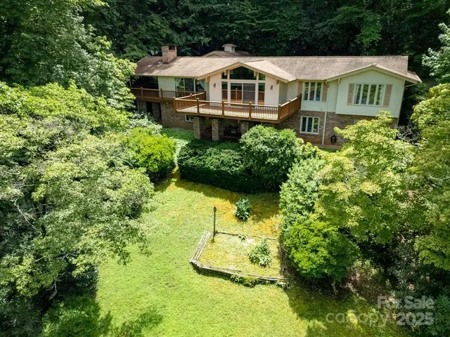 a aerial view of a house with a yard and plants