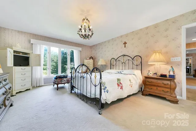 a view of a bedroom with furniture window and a flat screen tv