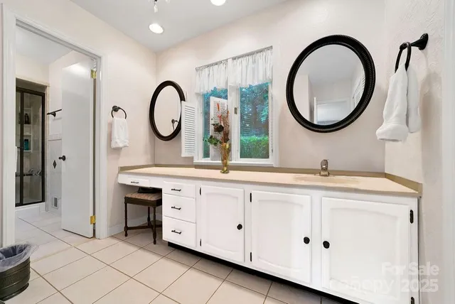 a bathroom with a double vanity sink and a mirror