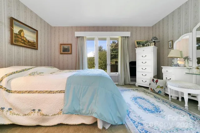 a spacious bedroom with a bed and a dresser