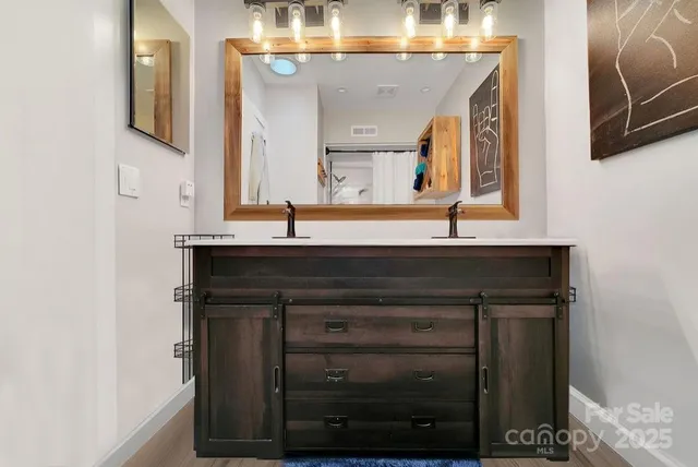 a bathroom with a sink vanity and mirror