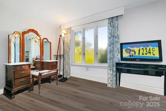 a living room with furniture and a floor to ceiling window