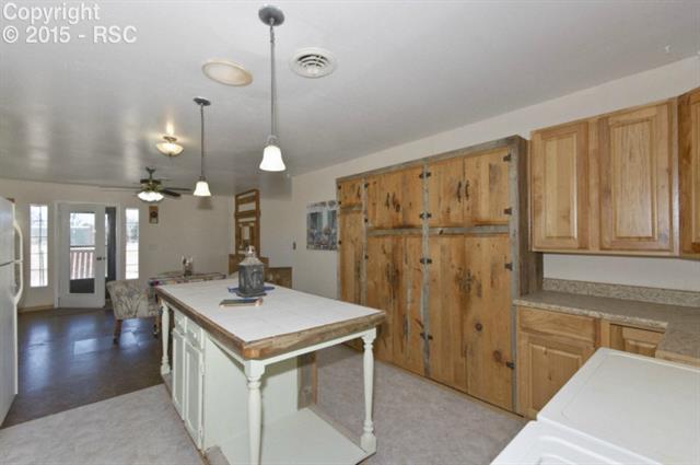 17135 Finch Road Colorado Springs, CO 80928 - Photo 27 of 36 Spacious kitchen with island in secondary home!