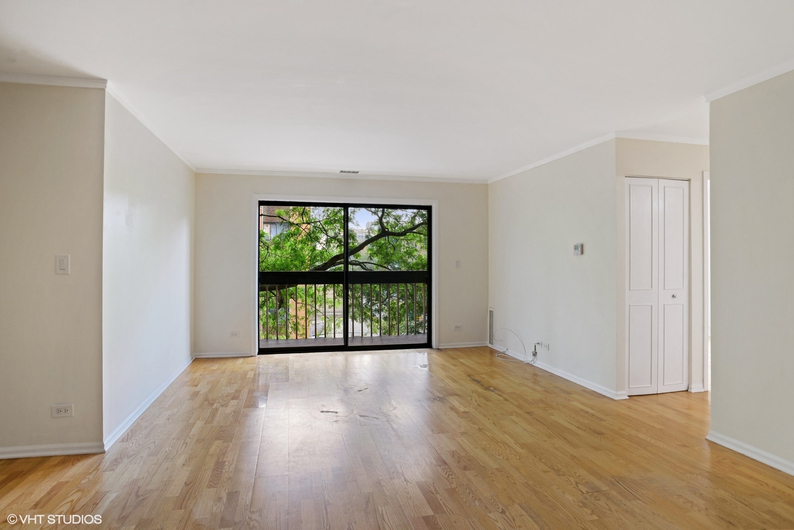 6102 North Sheridan Road, Unit 307 Chicago, IL 60660 - Photo 2 of 10 a view of an empty room with wooden floor and a window