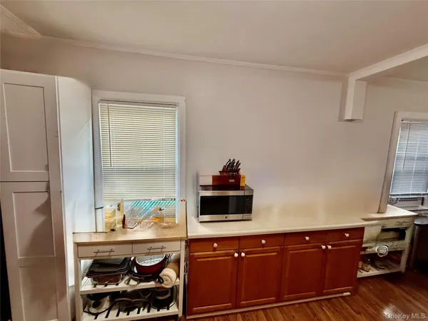 a view of kitchen with cabinets and wooden floor