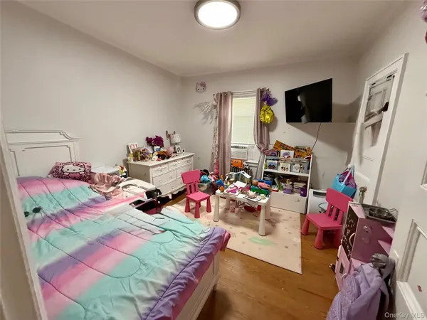 a bedroom with furniture and a flat screen tv