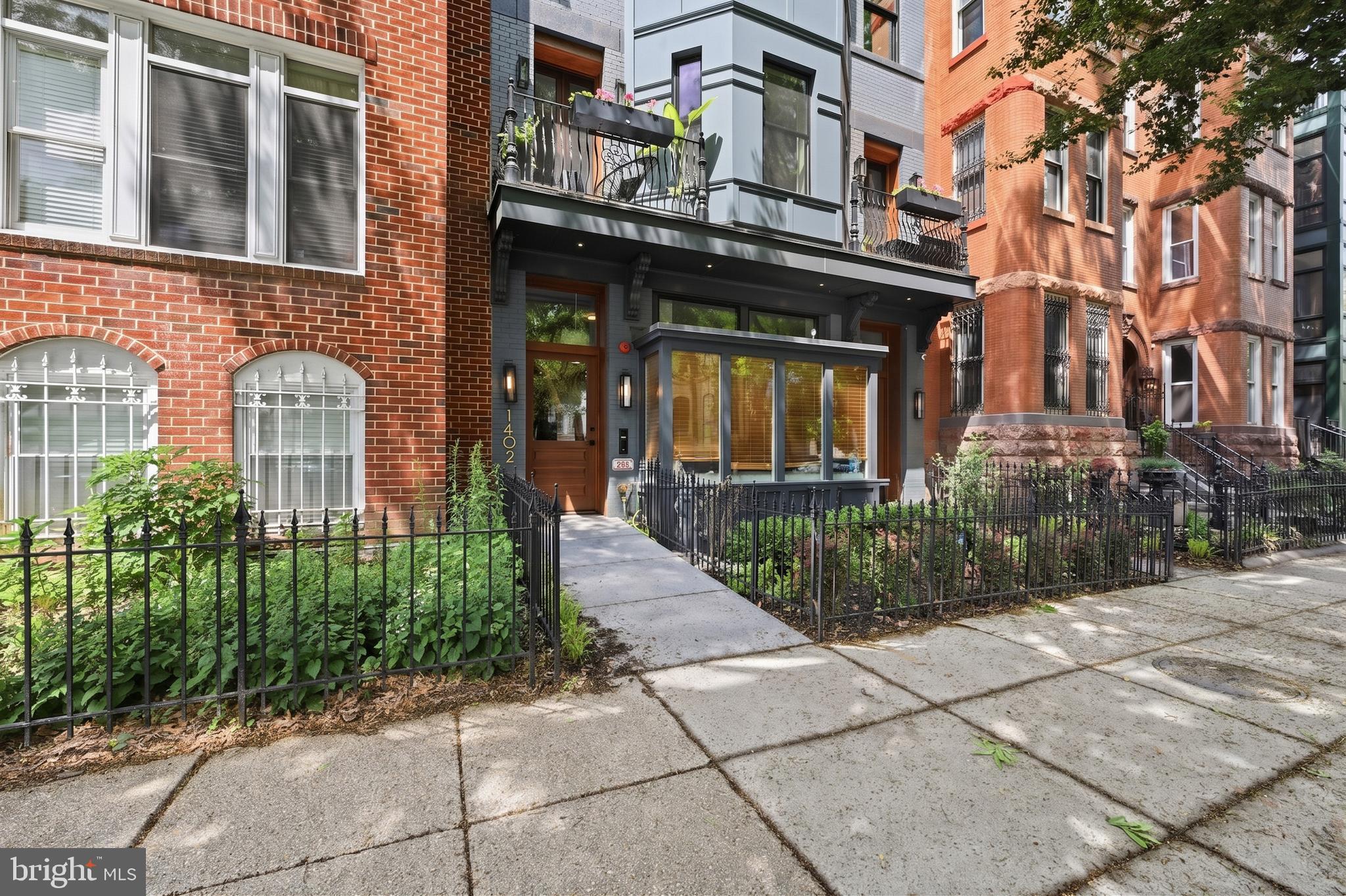 1402 12th Street Northwest, Unit 3 Washington, DC 20005 - Photo 1 of 23 a front view of a brick building with a yard